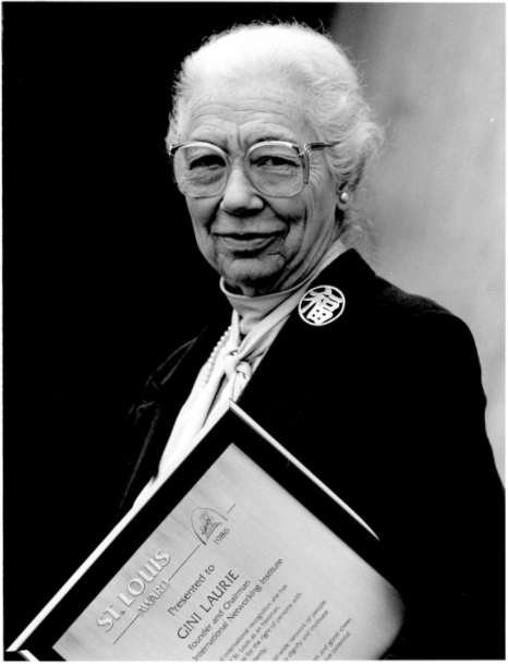 Black and white photo of woman with award